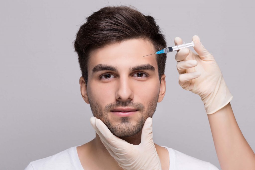 applying of dermal filler on a men’s face